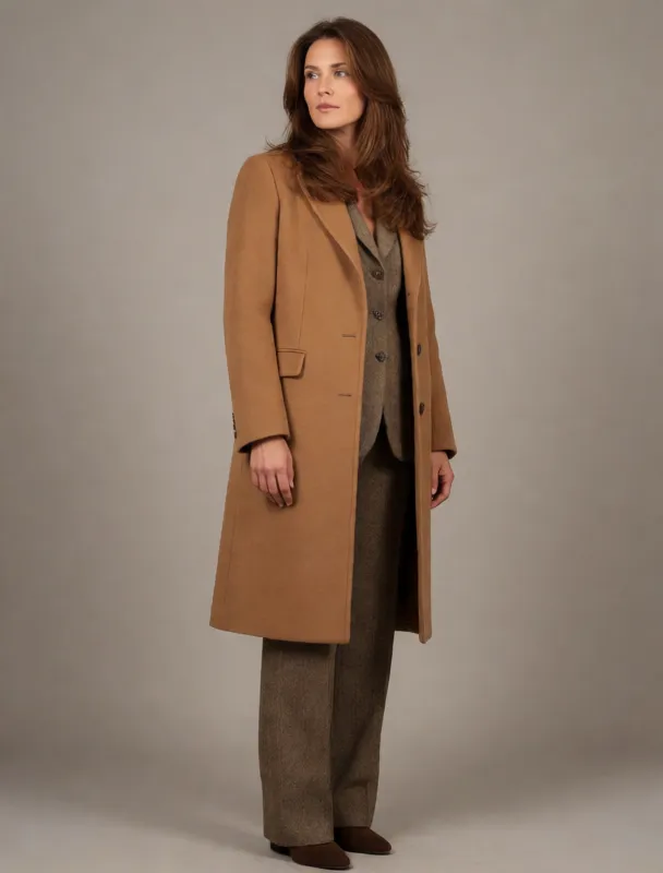 camel wool coat over a tweed suit by krea 2